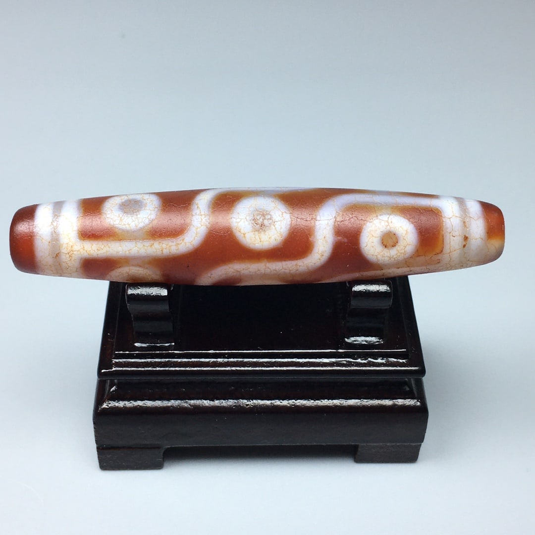 Tibetan red nine-eyed bloodshot cracked old dzi bead: Tibetan Red Nine-Eyed Blood-Veined Cracked Dzi Bead, Approximately 69.6 x 14.3 cm, Material: Agate Chalcedony. Nine-Eyed Dzi Beads: The finest of all Dzi beads, possessing the energy and effects of al