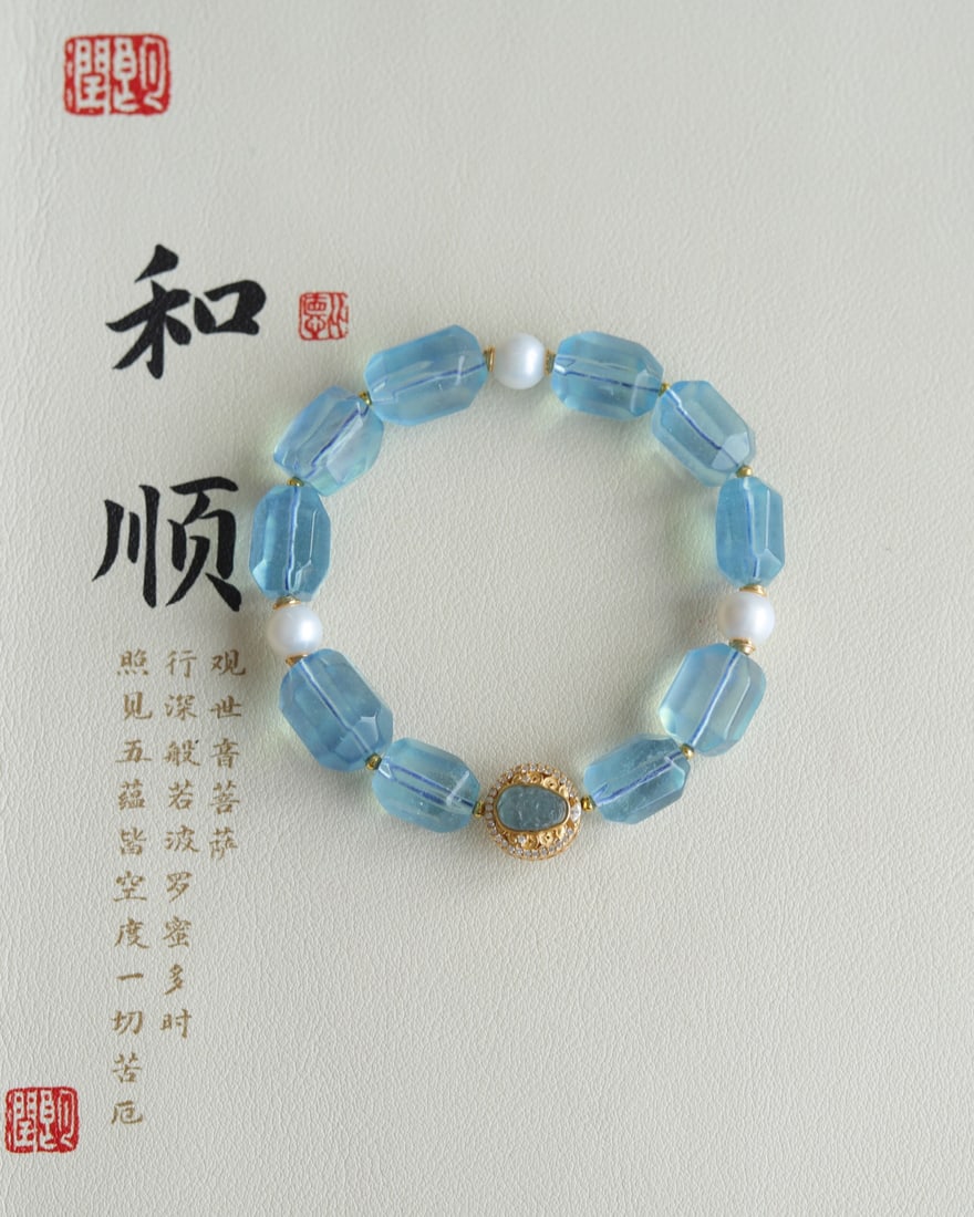 Natural aquamarine faceted freeform bracelet: This natural aquamarine freeform bracelet, approximately 12mm in size, is paired with a sterling silver and gold-plated blue tourmaline pendant with a finely carved Pixiu design and freshwater pearl a