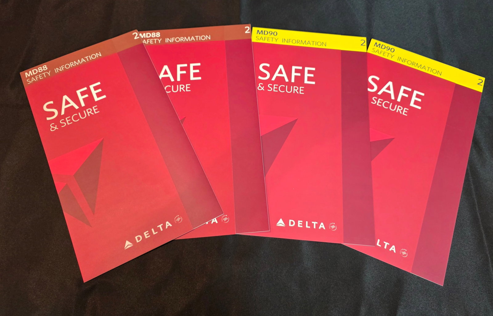 Delta Airlines Safety Cards: Four Delta Airlines safety cards from 2015. Two MD-88(November) and Two MD-90 (November). 25% of all proceeds from the sale of this lot will be donated to the Raise Your Banner Foundation, a