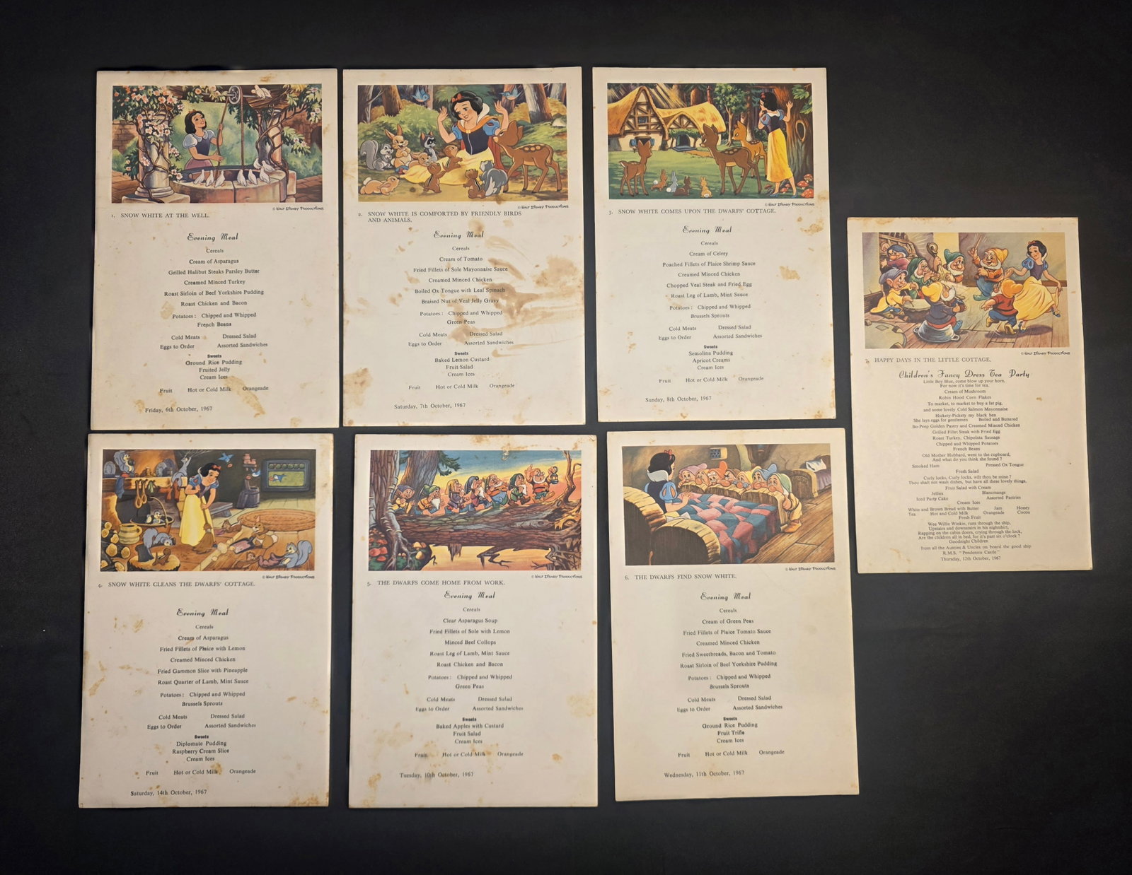 Union Castle Line R.M.M.V. Pendennis Castle Disney's Snow White Children's Menus: Seven children's dinner menus from Union Castle Line's R.M.M.V. Pendennis Castle. Each menu depicts a scene from Disney's Snow White . Menus numbered 1-7 and dated October 6th, 7th, 8th, 10th, 11th, 1