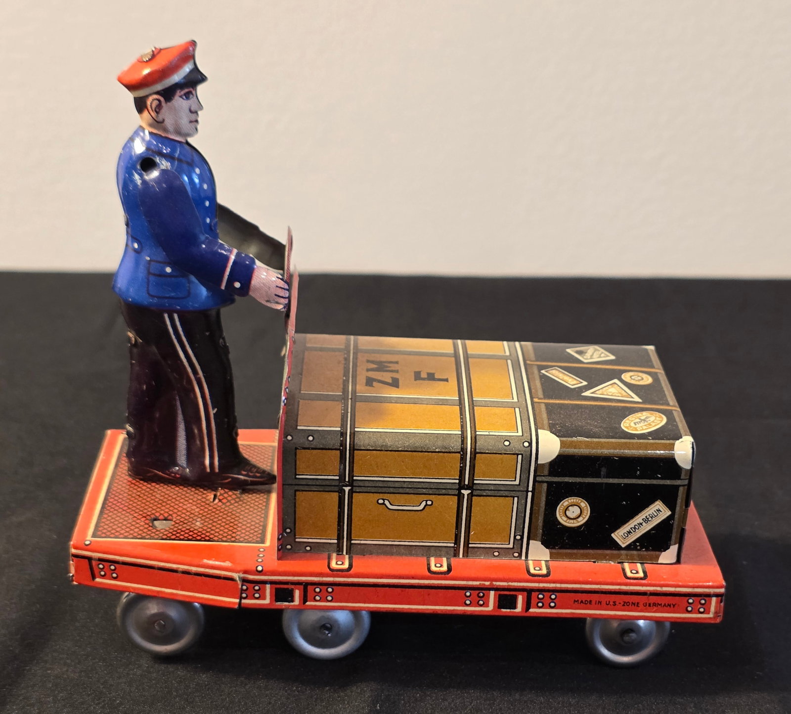 Fuchs Tin Luggage Porter: W. Germany. Dates from the 1960s. 50% of all proceeds from the sale of this lot will be donated to the Raise Your Banner Foundation, a Washington DC based non-profit whose mission is to break down