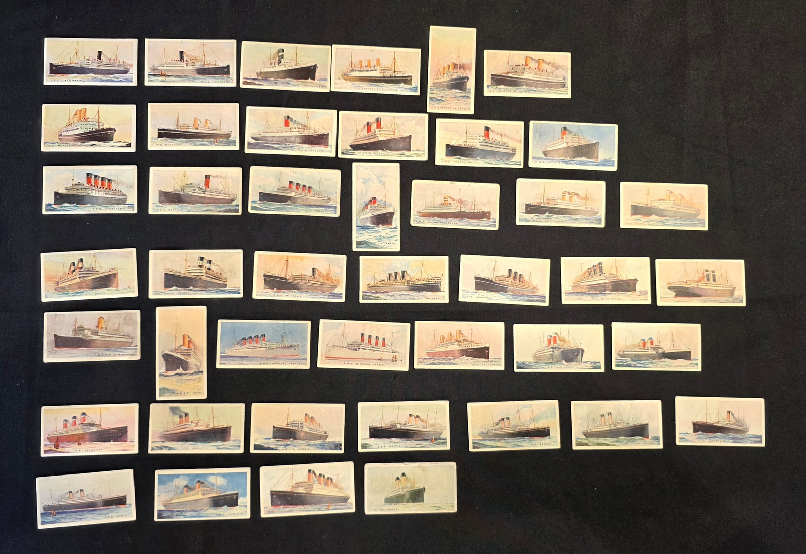 Merchant Ships of the World Cigarette Cards: 44 total, Imperial Tobacco of Canada Limited tobacco cards. Missing card # 2,8,12,13,48.50. Date: 1920s. 50% of all proceeds from the sale of this lot will be donated to the Raise Your Banner