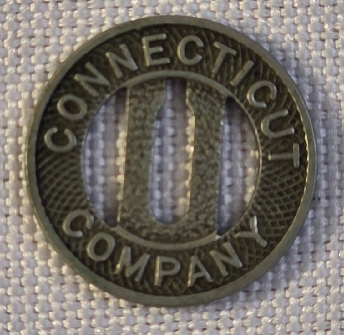 Connecticut Company Train Token: 16mm, 1940s. 50% of all proceeds from the sale of this lot will be donated to the Raise Your Banner Foundation, a Washington DC based non-profit whose mission is to break down the stigma surrounding m