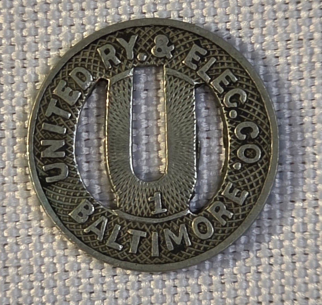 Baltimore United Railway & Electric Company Token: 16mm, 1910s. 50% of all proceeds from the sale of this lot will be donated to the Raise Your Banner Foundation, a Washington DC based non-profit whose mission is to break down the stigma surrounding