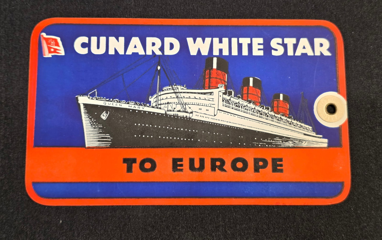 R.M.S. Queen Mary Luggage Tag: Original tag blank, 6 1/2" x 3 3/4". 50% of all proceeds from the sale of this lot will be donated to the Raise Your Banner Foundation, a Washington DC based non-profit whose mission is to break down
