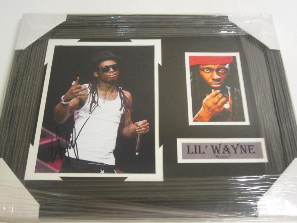 Lil' Wayne Weezy Signed Display: Lil' Wayne "Weezy" signed 8x10 color photo professionally custom framed and matted. Overall measurements are 16.5" 21". This comes with a certificate of authenticity (COA).