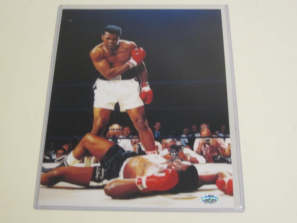 Muhammad Ali Signed 8x10 Photo: Muhammad Ali vs Sonny Liston signed by Muhammad Ali..8x10 color photo. This comes with a certificate of authenticity (COA)