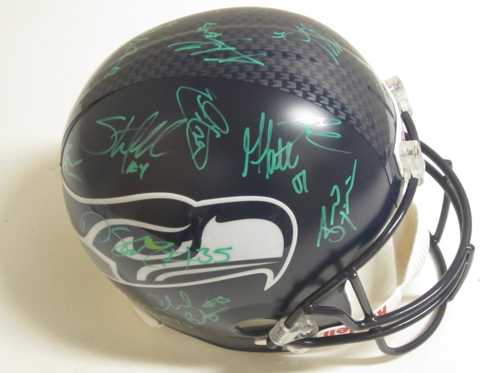 Seahawks Team Signed Helmet: Seattle Seahawks Super Bowl Champs 2013 signed / autographed full size Riddell replica helmet. There are 26 signatures on this ball...included are Golden Tate, Cam Chanclor, Russell Wilson, Richard Sh