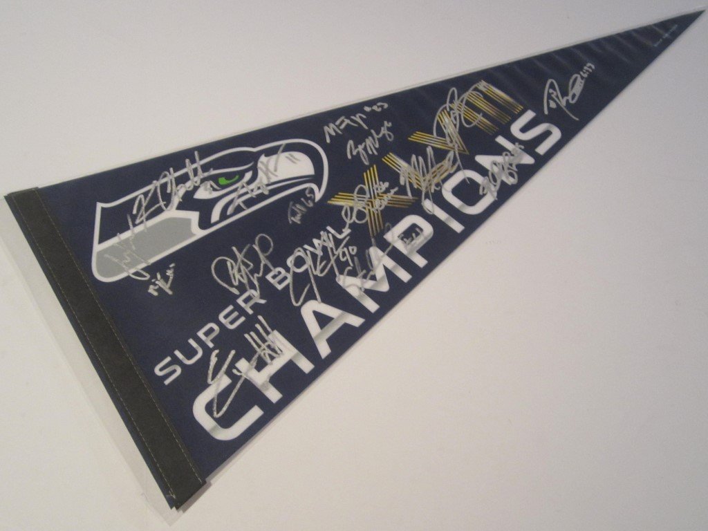 2014 Seahawks SB Signed Pennant: 2014 Seattle Seahawks Super Bowl hand signed team pennant. There are 15 signatures, included are: Russell Wilson, Marshawn Lynch and Richard Sherman. This comes with a Certificate of Authenticity fr