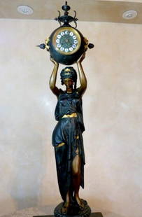 CIRCA 1880 SECOND FRENCH EMPIRE CLOCK NEWEL POST WITH: CIRCA 1880 SECOND FRENCH EMPIRE CLOCK NEWEL POST WITH FIGURAL BRONZED SPELTER, PATINATED AND GUILD WITH AUTHENTIC ORIGINAL KEROSENE LAMP ON A VICTORIAN WOMAN HOLDING A CERAMIC FACED TWO WIND CLOCK IN