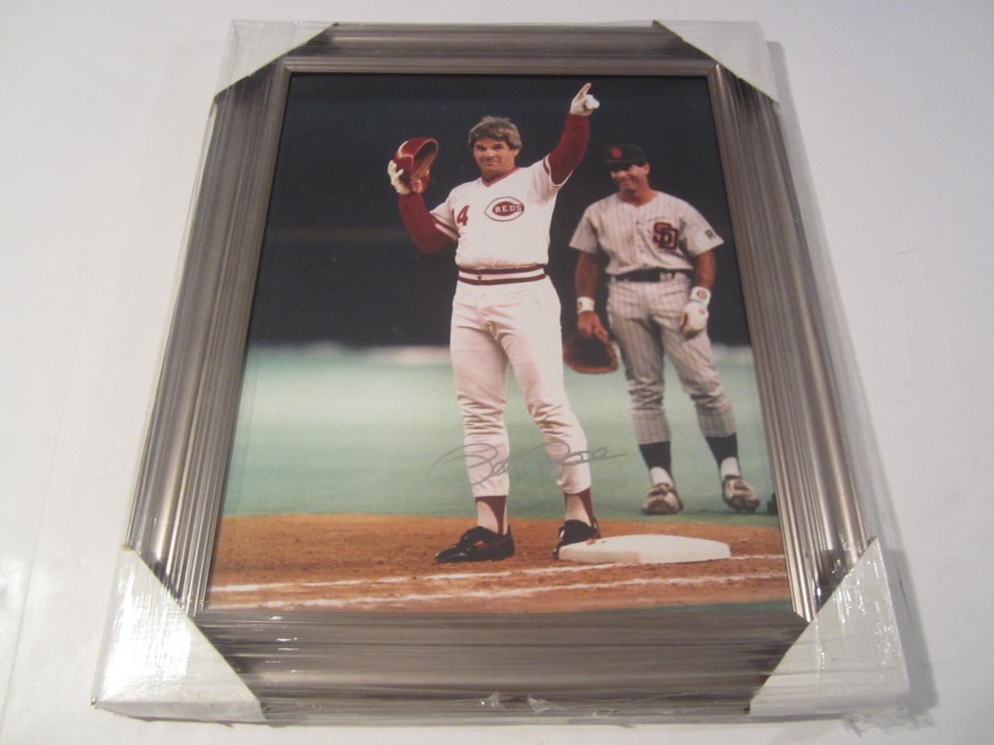 Pete Rose signed photo: This is a signed / autographed 16x20 framed photo. This has been signed by all time hit king Pete Rose of the Cincinnati Reds. It has been certified and authenticated by Authenticated Ink (AI) # E5041