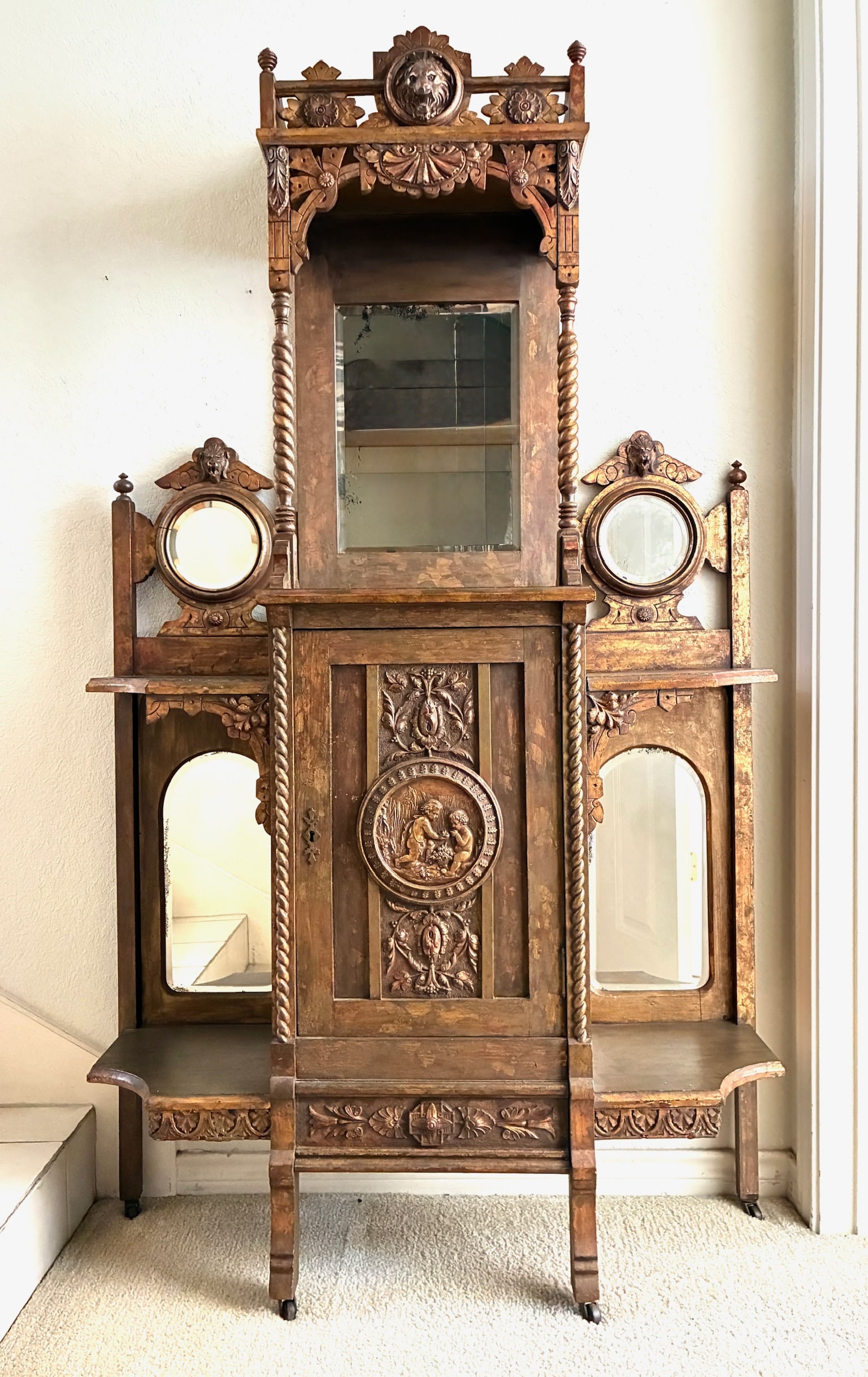 Victorian Antique Eastlake Etagere: Victorian Etagere with carved faces, mirrors shelves and cabinet. 40" x 12" x 69"