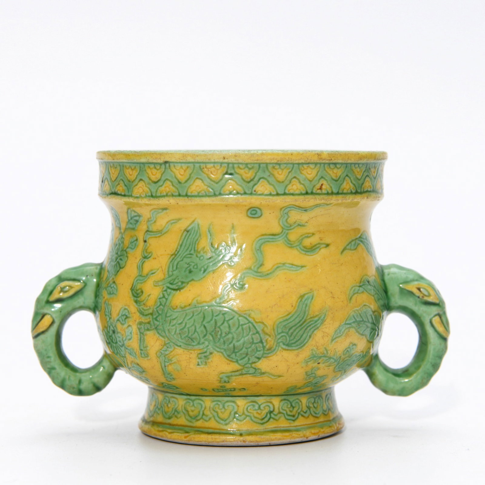 WANLI YELLOW-GROUND GREEN-ENAMEL DRAGON CENSER: Dimensions: 3 x 4 3/8 in This Wanli yellow-ground green-enamel dragon censer displays a lively and highly decorative visual character through its vivid colour palette and energetic dragon