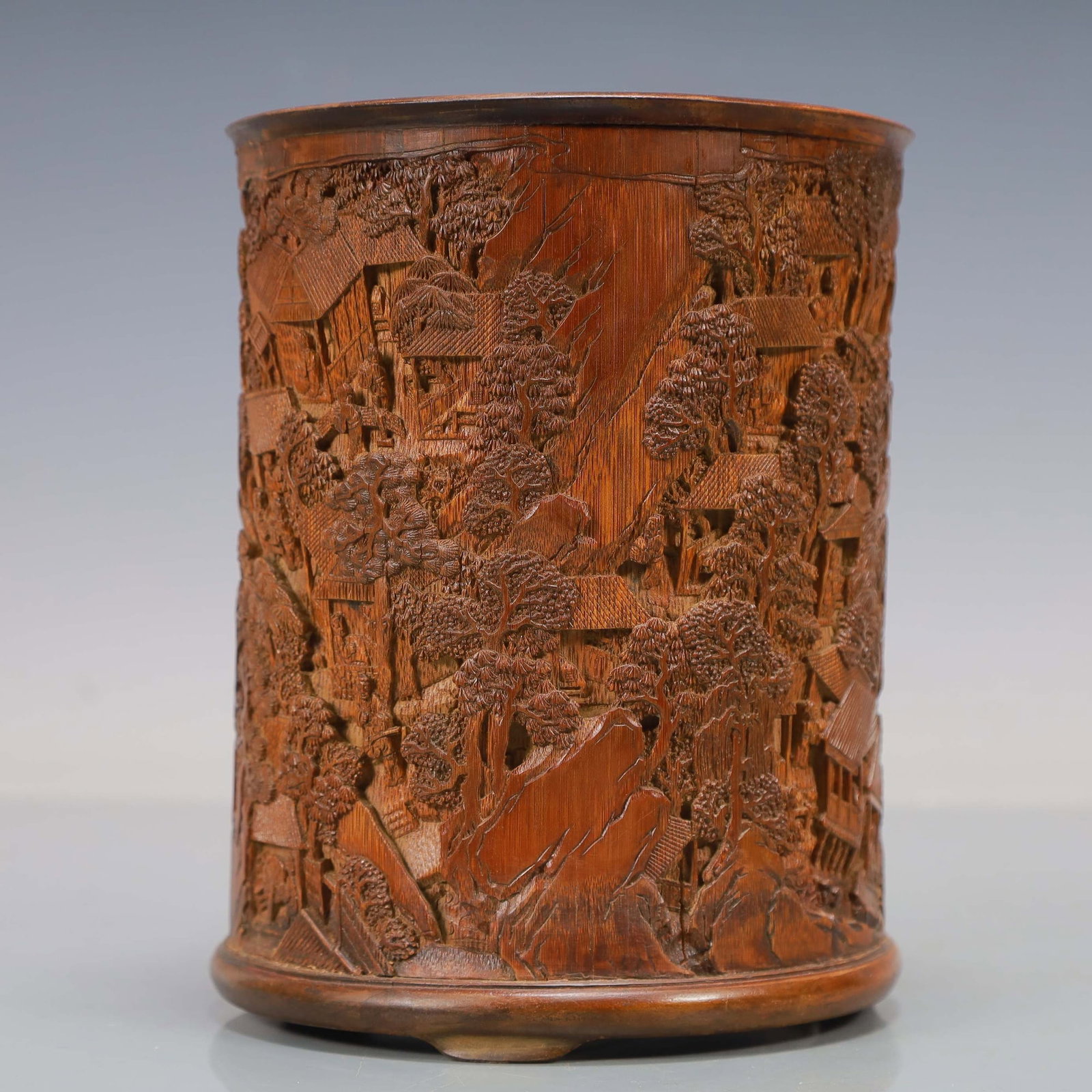 BAMBOO CARVED "WANJIA AN" BRUSHPOT: Dimensions: 7 1/8 x 5 7/8 in; weight 700 g This bamboo carved "Wanjia An" brushpot presents a lively narrative composition enriched by intricate openwork carving and refined scholar's taste. The cylin