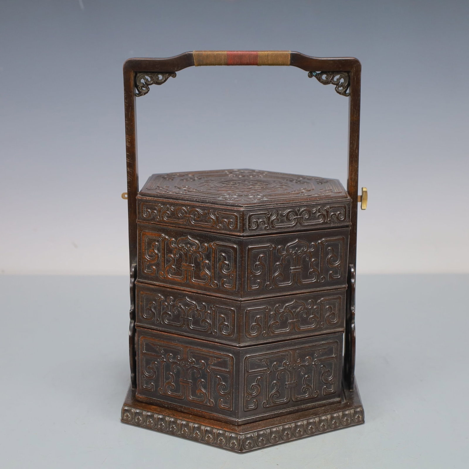 ZITAN CARRYING BOX: Dimensions: 10 5/8 x 3 1/2 in; weight 1450 g This zitan carrying box presents a refined combination of practicality and elegant hardwood craftsmanship. The rectangular body is richly decorated with