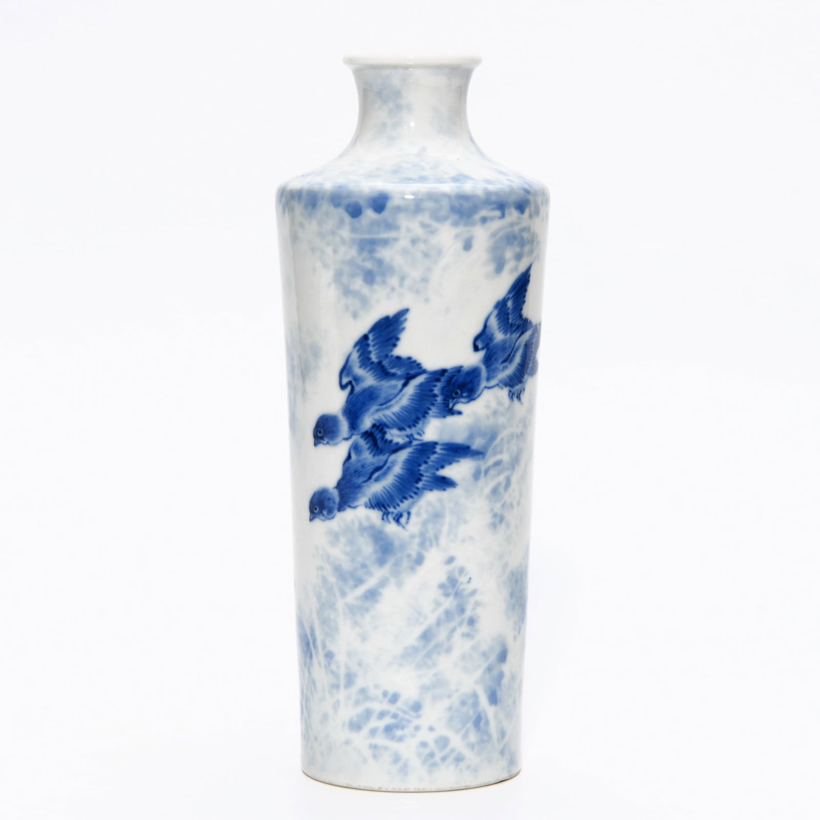 WANG BU BLUE AND WHITE FLORAL VASE: Dimensions: 7 1/2 x 2 7/8 in This Wang Bu blue and white floral vase demonstrates an elegant painterly style combined with a refined porcelain form. The tall cylindrical body is decorated with