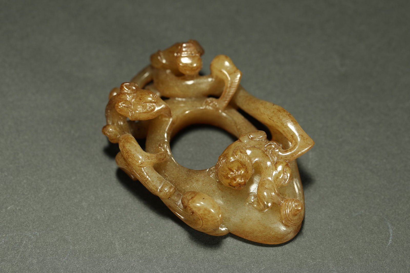 HETIAN JADE CHICKEN-HEART PENDANT: Dimensions: 2 1/4 x 1 3/8 in; weight 25.6 g This Hetian jade chicken-heart pendant presents a lively openwork composition enriched by flowing organic carving and natural jade coloration. The pendant