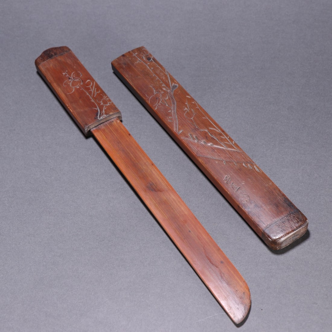 BAMBOO CARVED POETIC PAPER KNIFE: Dimensions: 10 3/4 x 1 1/2 in; weight 60 g This bamboo carved poetic paper knife presents a refined scholarly aesthetic through its understated form and delicate engraved decoration. The slender