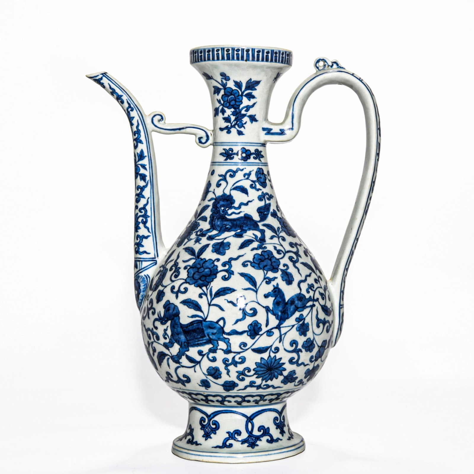 A JIAQING BLUE AND WHITE EWER: Dimensions: 13 3/8 x 6 3/8 in The pear-shaped body rising to a slender neck with a curved spout and loop handle, painted in underglaze blue with scrolling floral decoration. Dimensions: 13 3/8 x 6
