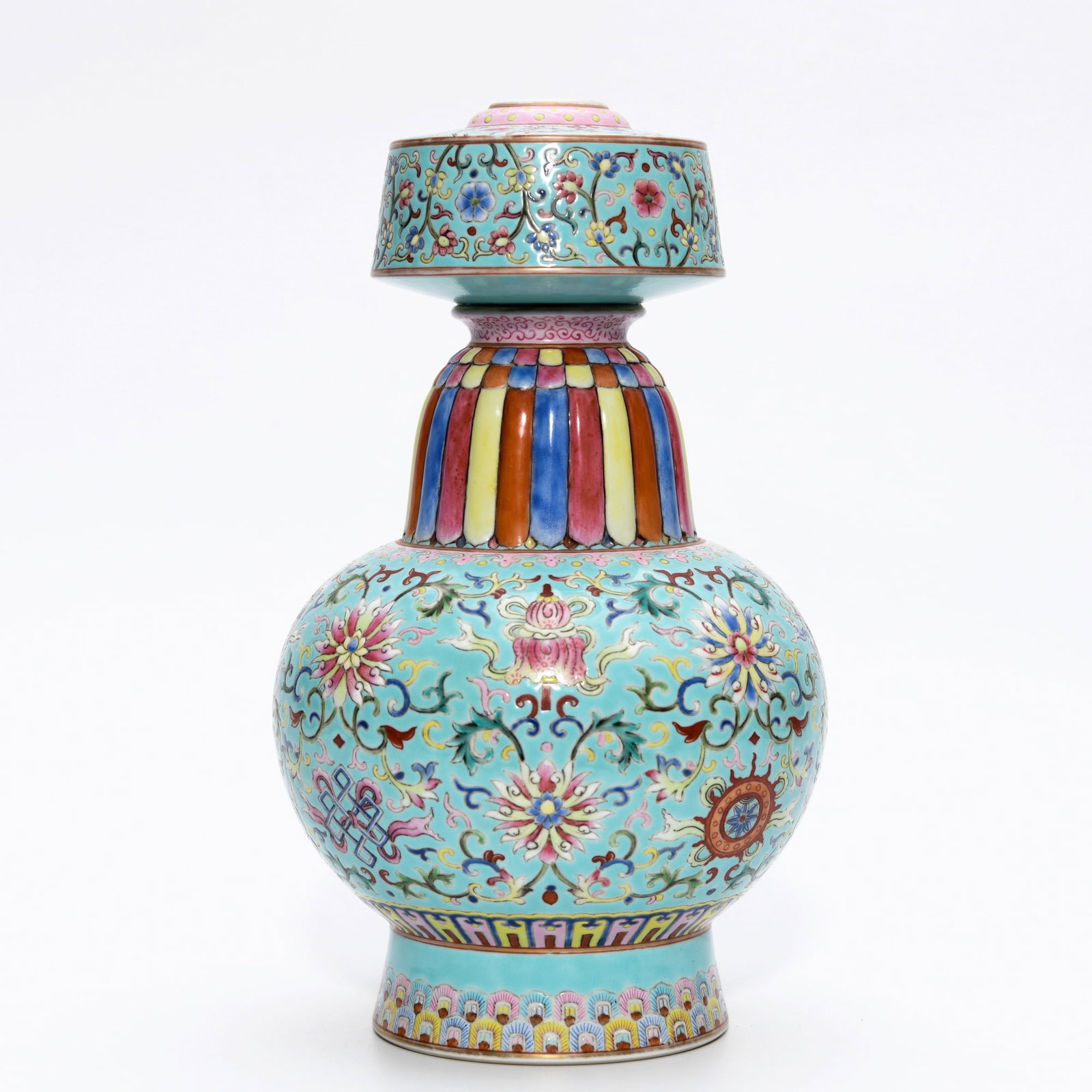 QIANLONG TURQUOISE-GROUND FAMILLE ROSE MOON FLASK: Dimensions: 10 3/8 x 6 1/2 in This finely enamelled Qianlong turquoise-ground famille rose moon flask presents a striking combination of vibrant colour and elegant form. The compressed body and