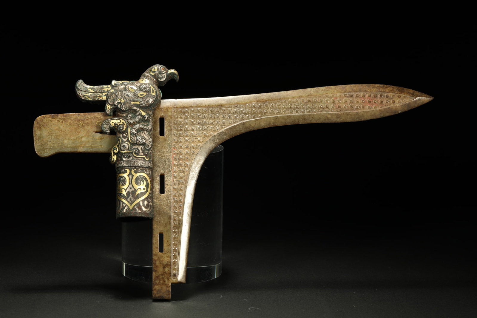 BRONZE GILT-SILVER JADE GE: Dimensions: 12 1/4 x 7 1/8 in; weight 387 g This bronze gilt-silver jade ge presents a striking ceremonial character through its combination of archaic weapon form and refined decorative