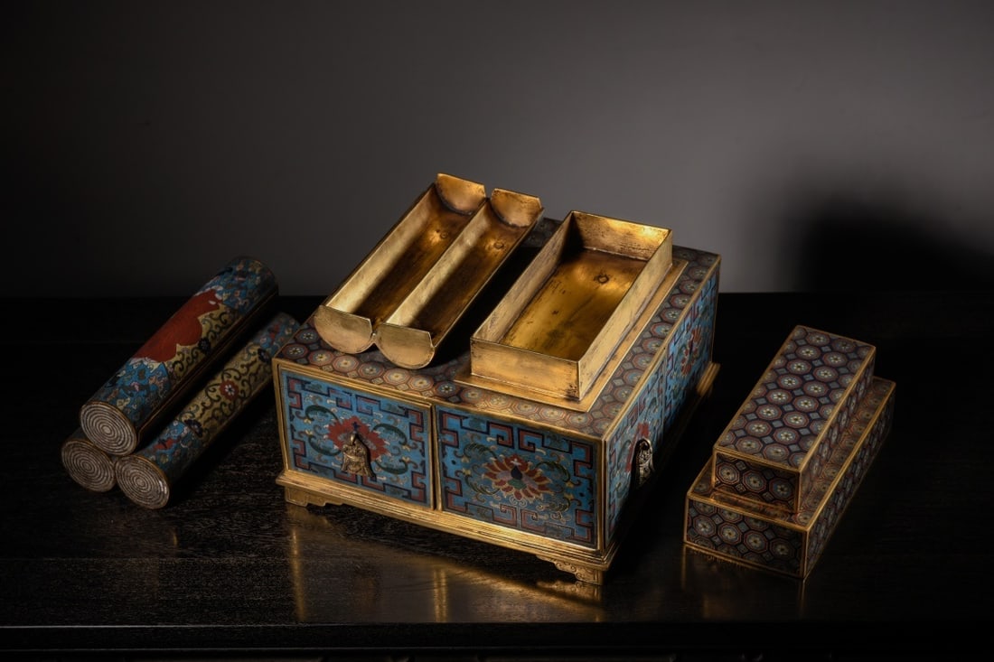 CLOISONNÉ ENAMEL FOUR-DRAWER COVERED BOX: Dimensions: 9 1/2 x 9 1/2 x 8 1/8 in This cloisonné enamel four-drawer covered box presents a richly decorative composition defined by vibrant enamels and intricate metalwork craftsmanship. The