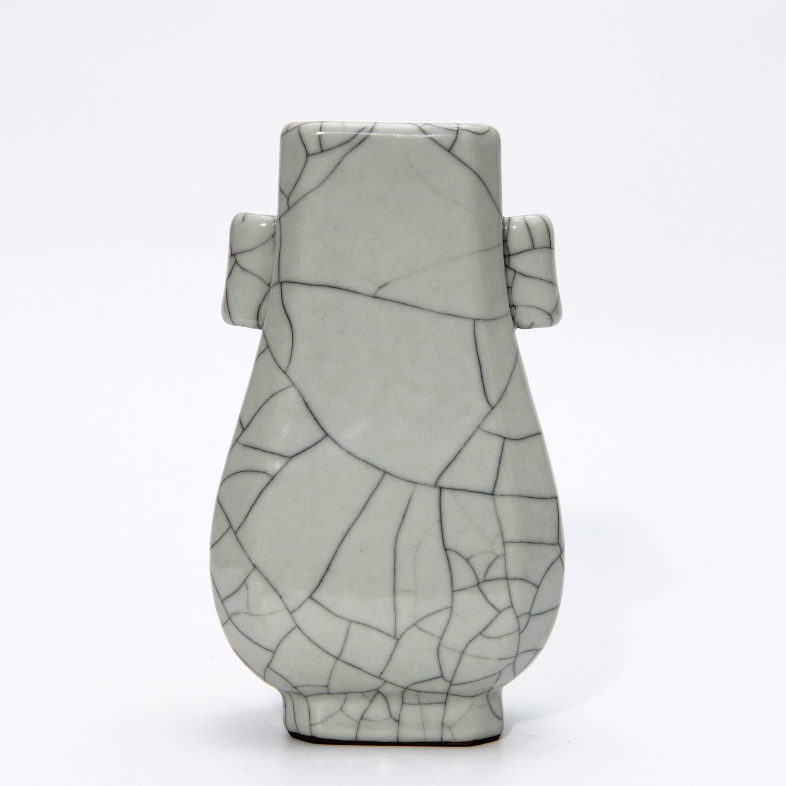QIANLONG GE-TYPE GLAZED VASE: Dimensions: 6 1/8 x 3 3/8 in This Qianlong Ge-type glazed vase displays a refined appreciation for archaic ceramic aesthetics through its elegant crackled glaze surface and sculptural form. The