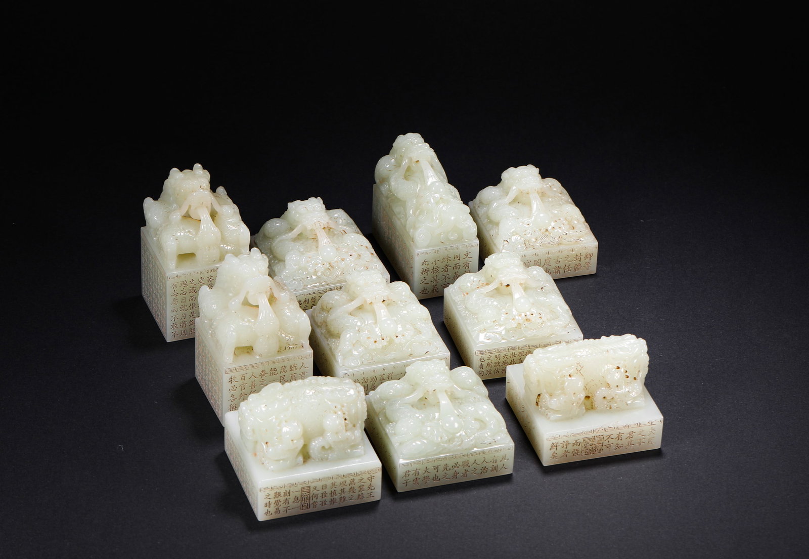 QING DYNASTY HETIAN JADE INTERLOCKING DRAGON BUTTON JADE SEAL SET SEAL: H:4cm(1.57in) W:4cm(1.57in) Weight:2030g(4.48lb)This set of imperial seals is a masterpiece of the craftsmanship of the Qing Dynasty Imperial Workshop. Carved from top-quality Hetian white jade, it fe