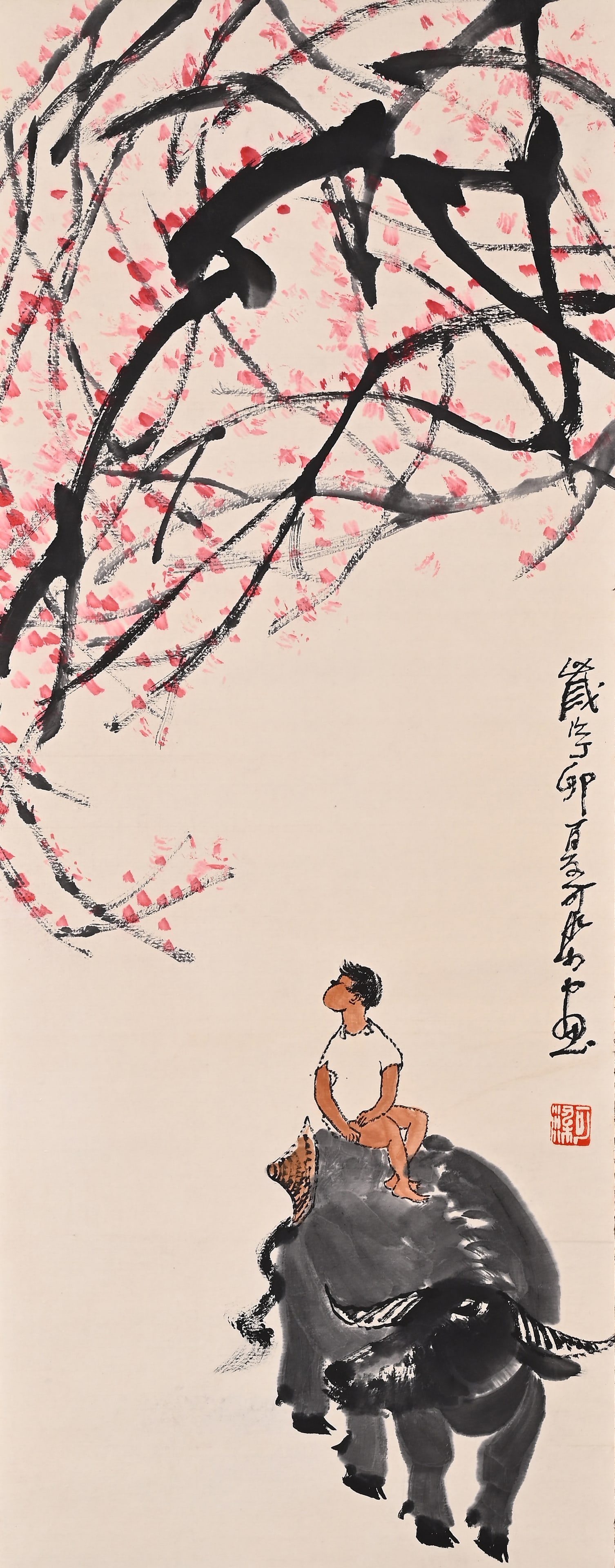 A VERTICAL SCROLL IN THE STYLE OF LI KERAN (1907-1989): Height:102cm(40.16in) Width:40cm(15.75in)Cowherd painting scroll in Li Keran style. Pale ink painting of boy sitting on buffalo, red plum blossoms above, signature and seal on right, antique patterned