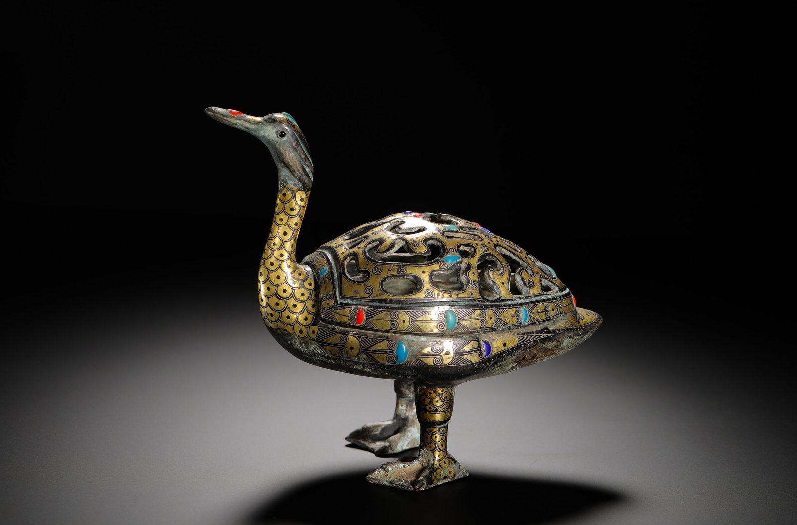 HAN DYNASTY BRONZE INLAID GOLD AND SILVER WITH TURQUOISE DUCK-SHAPED INCENSE: H:17cm(6.69in)W:16.5cm(6.50in)Weight:860g(1.90lb)These objects were used by the nobility to burn incense, serving both practical and decorative purposes. The duck motif symbolized good fortune and pur