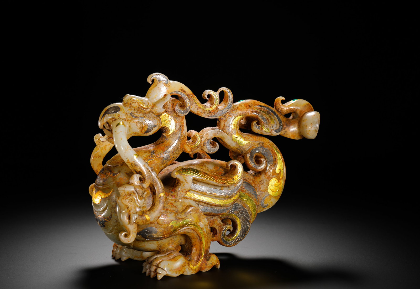 HAN DYNASTY HETIAN JADE INLAID WITH GOLD AND SILVER DRAGON AND PHOENIX AUSPICIOUS BEASTS: Height:16cm(6.30in) Width:21cm(8.27in) Weight:2210g(4.87lb)Han Dynasty ornament carved from Hetian jade with gold and silver inlaid phoenix-dragon design. The white jade bears natural burial patina, f