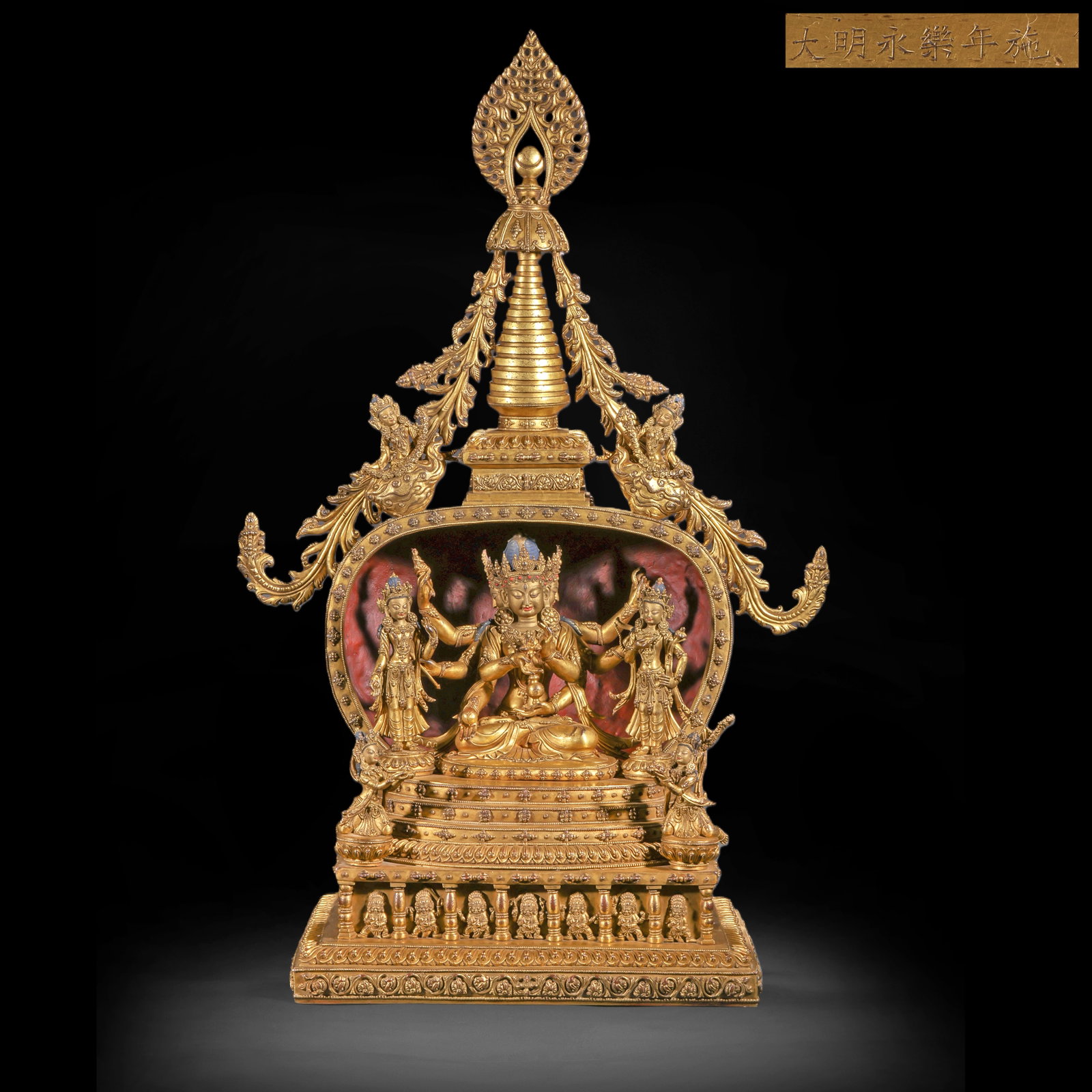 A GILDED BRONZE BUDDHA WITH THREE FACES, SIX ARMS AND TWO BODIES IN THE MING DYNASTY: H:74.0cm(29.13in) W:45.0cm(17.72in) Weight:23900g(52.69lb)This statue is cast in bronze and gilded, depicting the main figure of Three-Faced, Six-Armed Yab-Yum Buddha (Guhyasamaja/Vajradhara). He sits