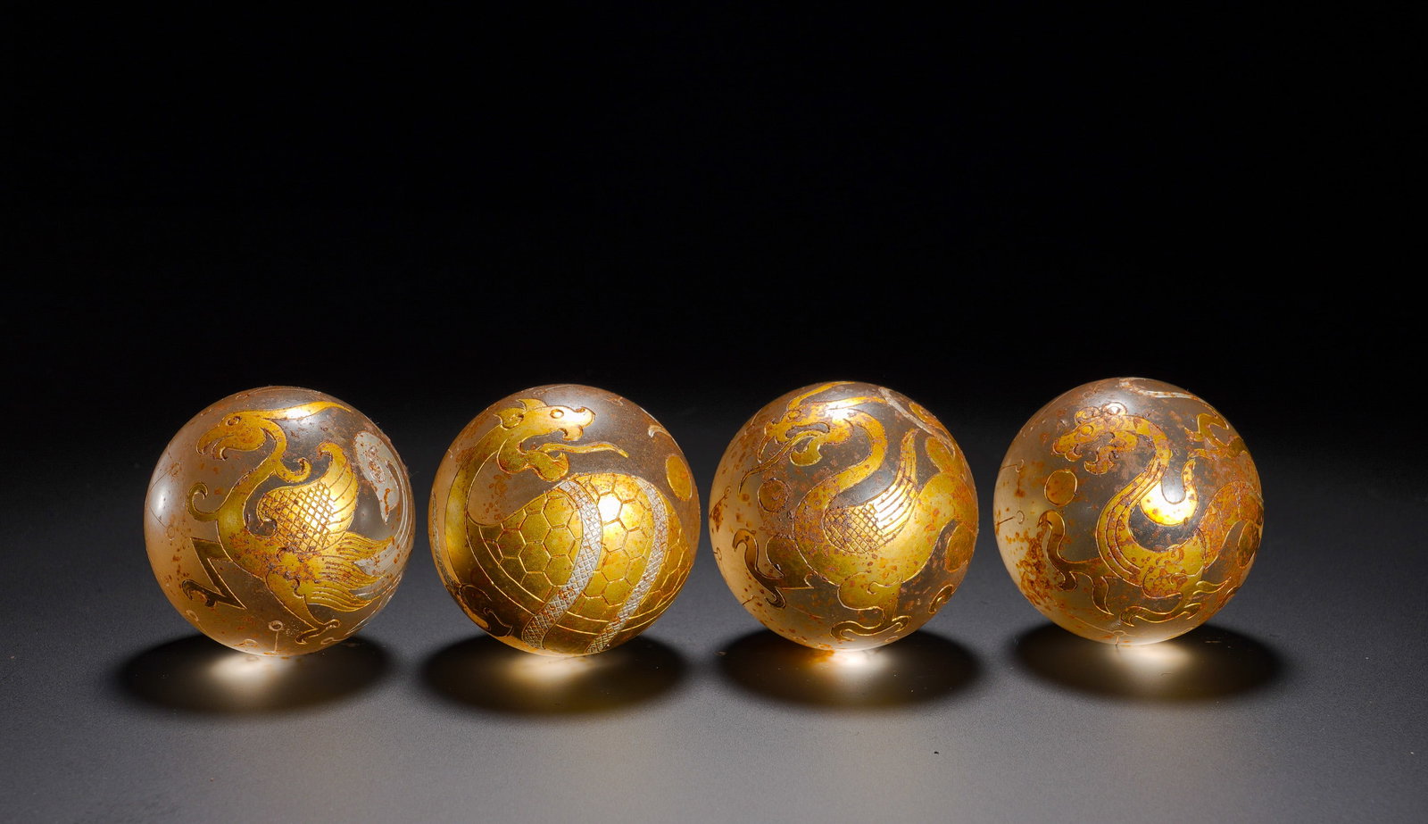 FOUR DIVINE BALLS INLAID WITH CRYSTAL FROM THE HAN DYNASTY