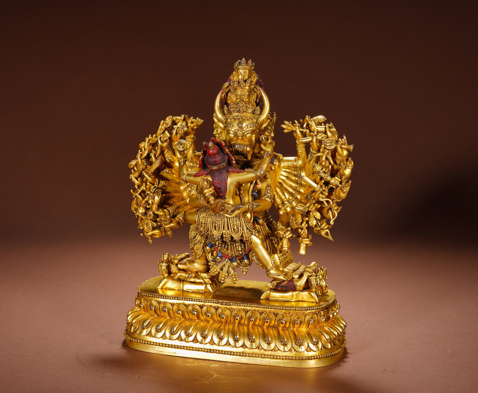 QING DYNASTY GILDED BRONZE STATUE OF VAJRAPANI VAJRAPANI DOUBLE BODY: Height: 25cm(9.84in), Width: 19cm(7.48in), Weight: 4230g (9.326lb)This fully gilded copper sculpture depicts Yamantaka, the bull-headed wrathful yidam, in yab-yum embrace with his consort. Multi-faced