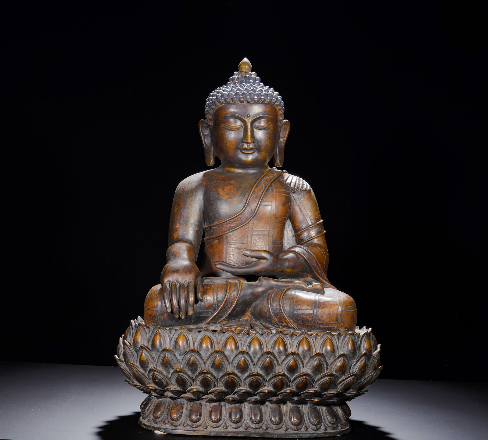 A BRONZE STATUE OF SAKYAMUNI BUDDHA FROM THE MING DYNASTY: Height: 60cm(23.62in), Width: 42cm(16.54in), Weight: 27150g (59.856lb)The enlightenment image of Shakyamuni enjoys enduring popularity. With dignified proportions and solemn aura, this substantial fig