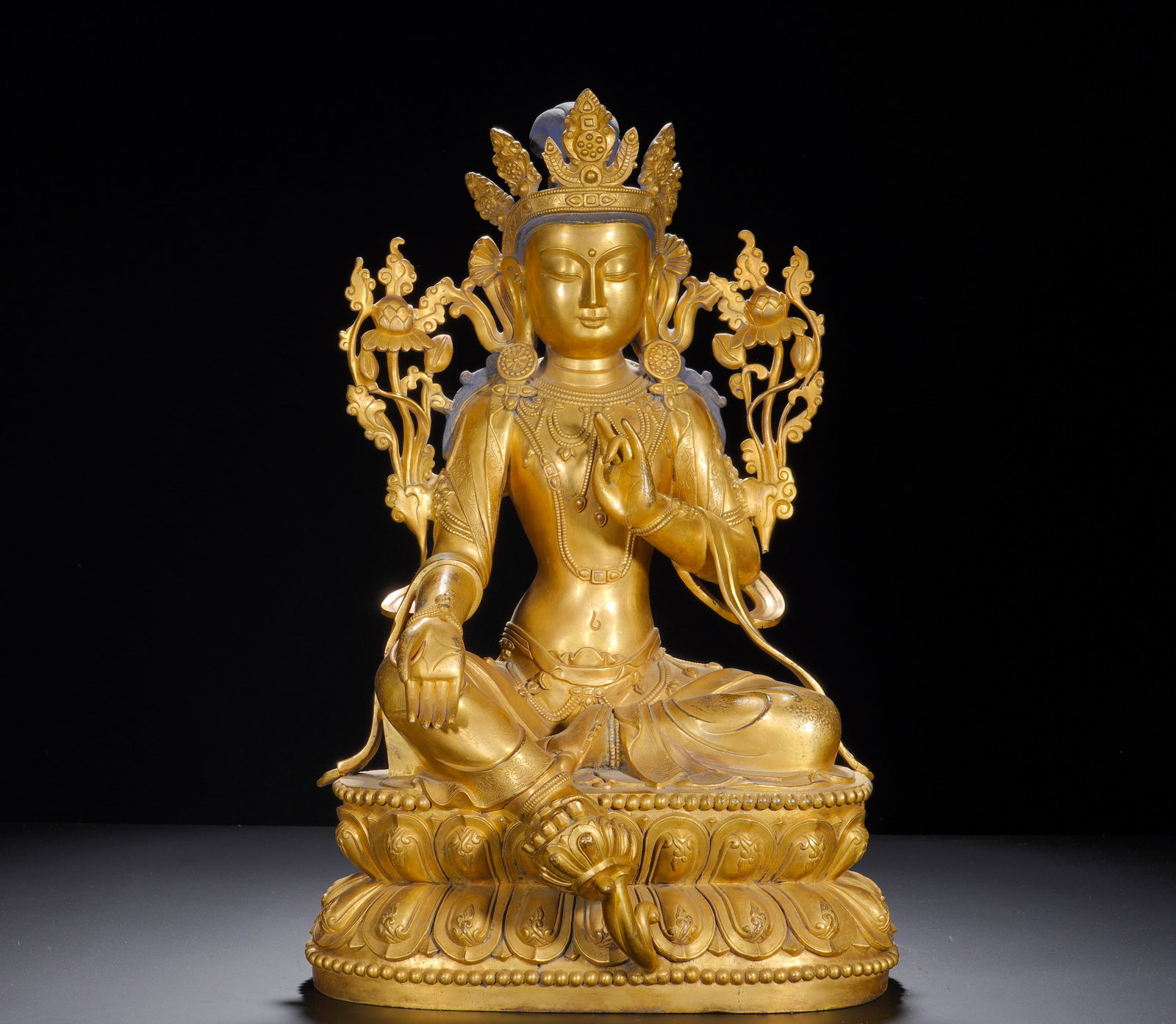 BRONZE GILDED GREEN TARA SITTING FIGURE OF THE MING DYNASTY: Height: 50cm(19.69in), Width: 33cm(12.99in), Weight: 18300g (40.341lb)Green Tara enjoys enormous popularity for auspicious symbolism of safety and deliverance. With harmonious proportions, gentle faci