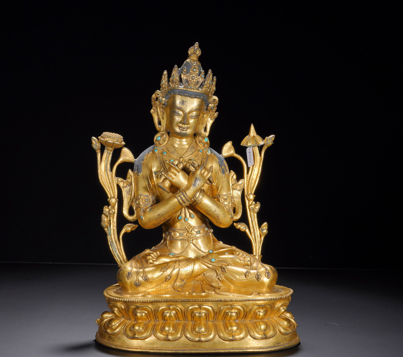 BRONZE GILDED VAJRA MASTER SEATED FIGURE OF THE MING DYNASTY: Height: 36cm(14.17in), Width: 25cm(9.84in), Weight: 7080g (15.609lb)His hands cross at the chest holding the vajra and ghanta bell, Vajradhara??s defining mudra and attributes. Lotus stems rise on eit