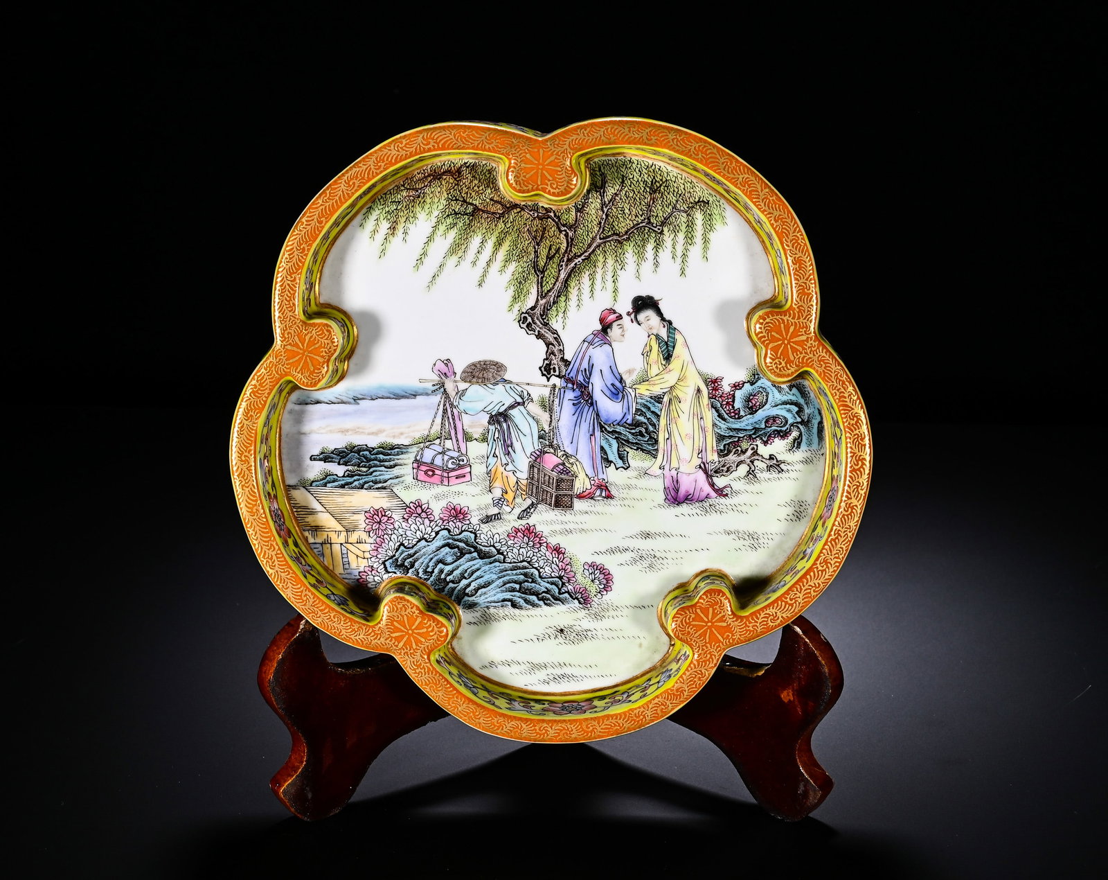 QING QIANLONG YELLOW GROUND PASTEL PLUM BLOSSOM-SHAPED FIGURE STORY PATTERN WASH: Diameter: 18cm(7.09in)Fashioned in elegant plum?blossom lobed form. The rim is decorated with iron?red gilt brocade pattern. The side walls are painted with dense famille?rose scrolling blossoms on br
