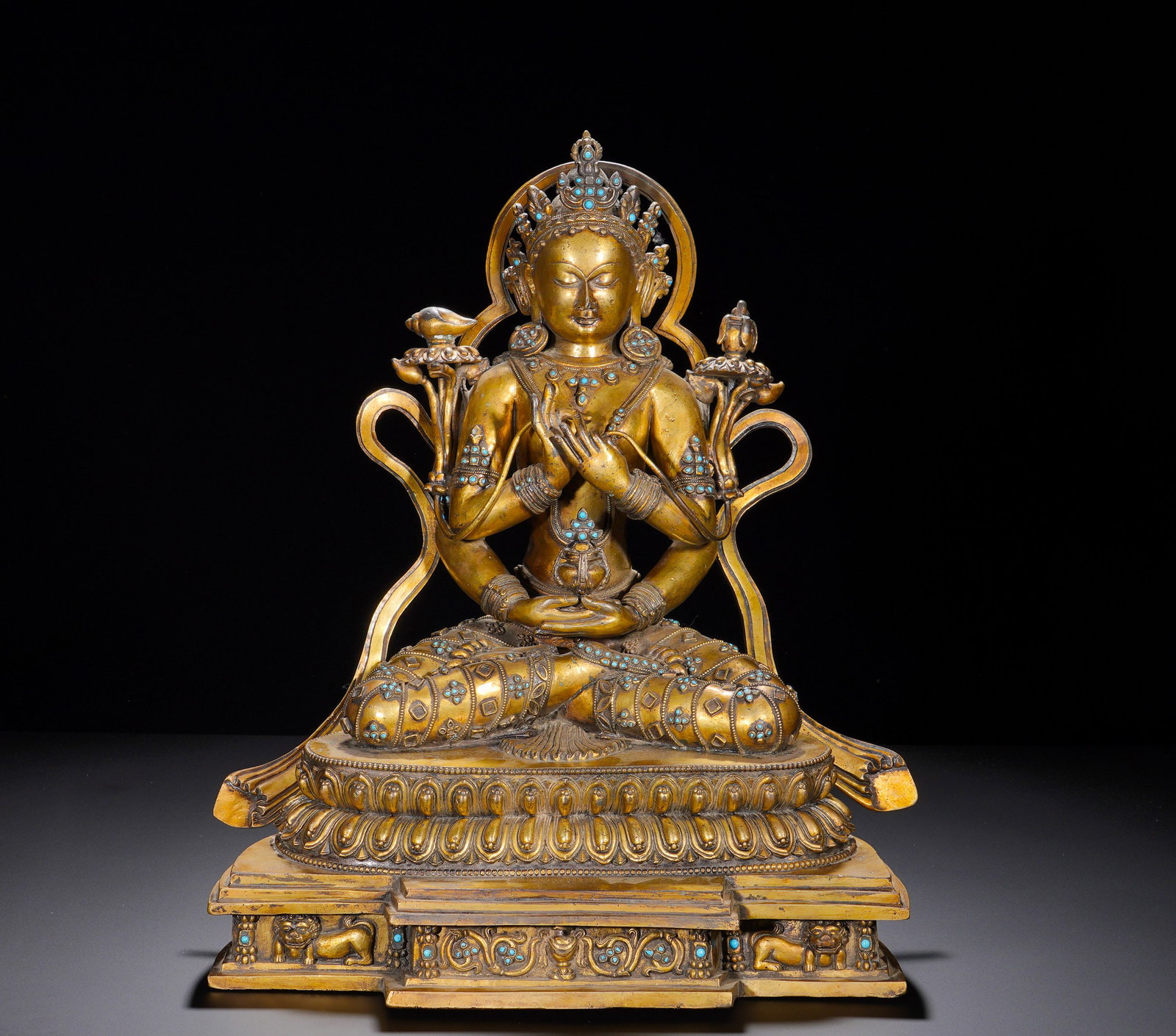 A GILDED BRONZE STATUE OF MANJUSRI BODHISATTVA INLAID WITH TURQUOISE FROM THE MING DYNASTY: Height: 46cm(18.11in), Width: 36cm(14.17in), Weight: 18650g (41.116lb)The aged patina and harmonious proportions reveal strong Nepalese-Tibetan artistic influence. As the patron of wisdom, intellect a