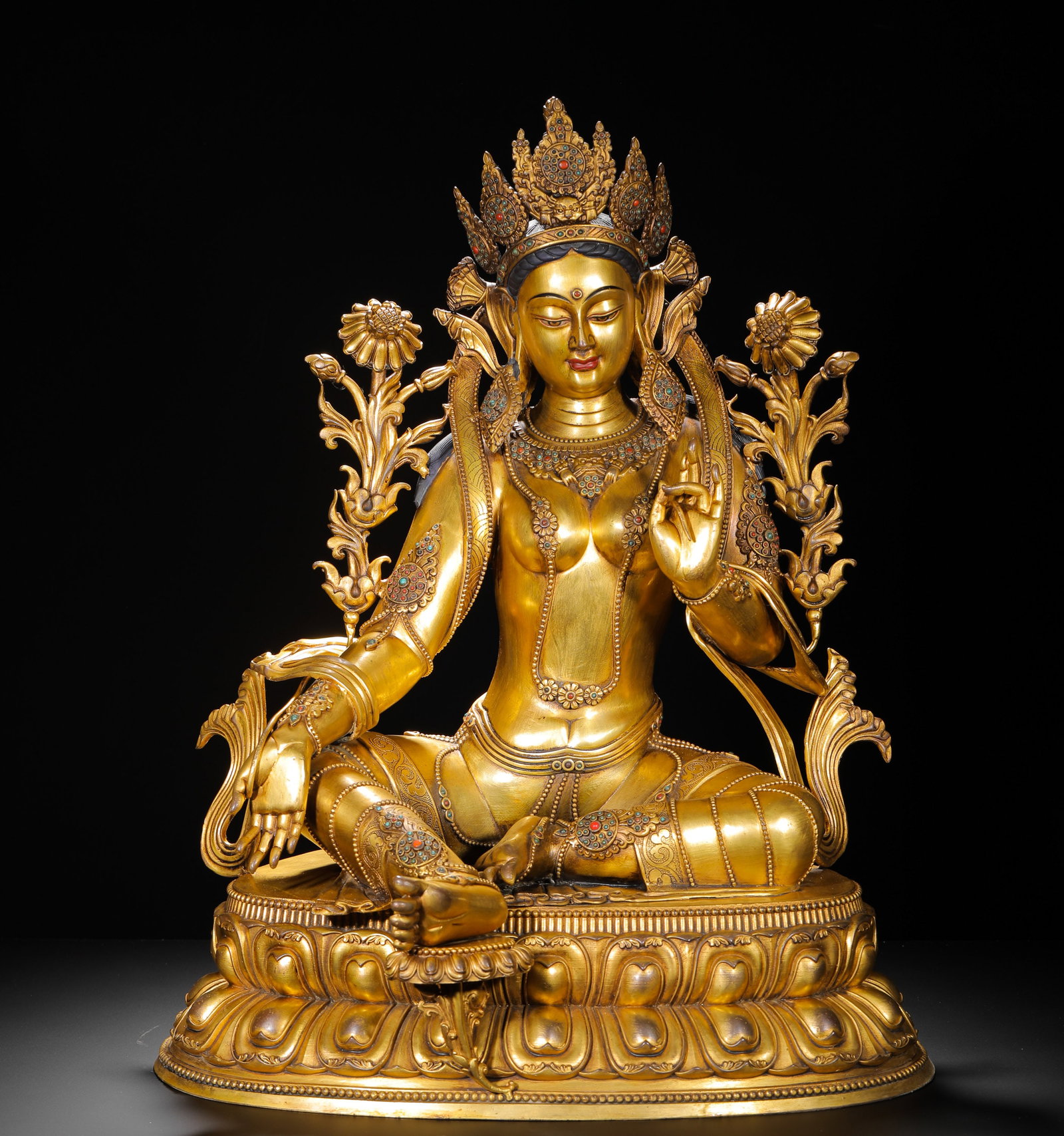 QING DYNASTY GILDED BRONZE STATUE OF THE WHITE TARA WITH INLAID TREASURES: H: 68cmW: 46cmWeight: 25000g Full gilded bronze seated White Tara statue, the longevity deity in Tibetan Esoteric Buddhism with gemstone inlay.