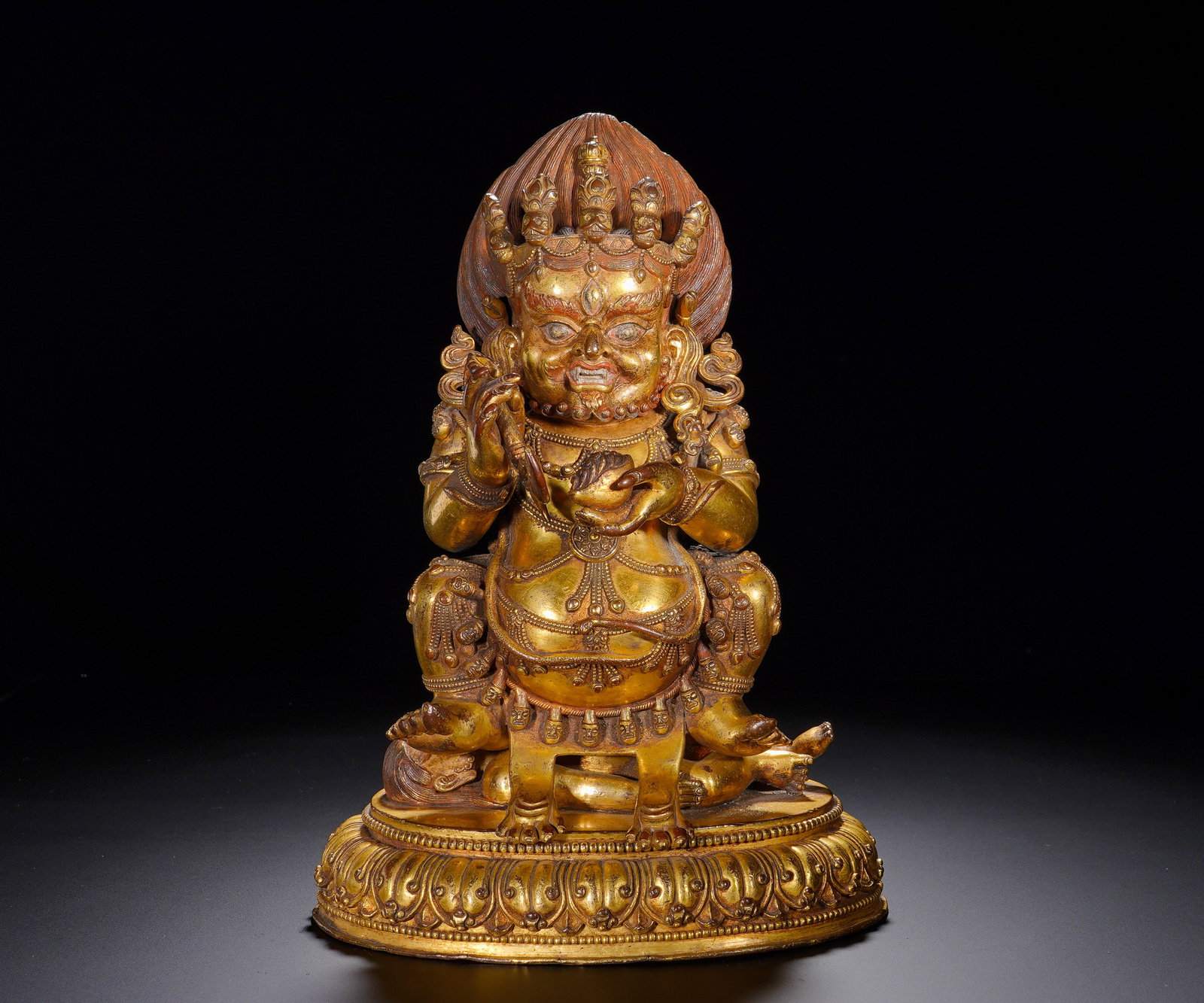 A GILDED BRONZE STATUE OF THE GREAT BLACK GUARDIAN OF THE MING DYNASTY: Height: 28cm(11.02in), Width: 20cm(7.87in), Weight: 3980g (8.774lb)Mahakala, also known as Black Deity, functions both as protector and wealth deity, revered for removing obstacles, safeguarding resou