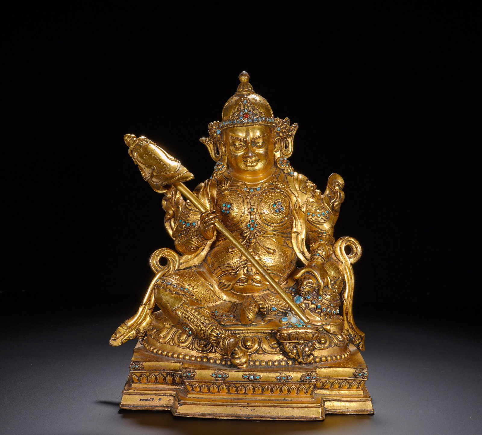 A GILDED BRONZE STATUE OF THE YELLOW GOD OF WEALTH FROM THE MING DYNASTY: Height: 25cm(9.84in), Width: 22cm(8.66in), Weight: 4480g (9.877lb)Vaisravana bestows wealth, safeguards property and removes poverty. Bronzes of Vaisravana with complete attributes and original gem in