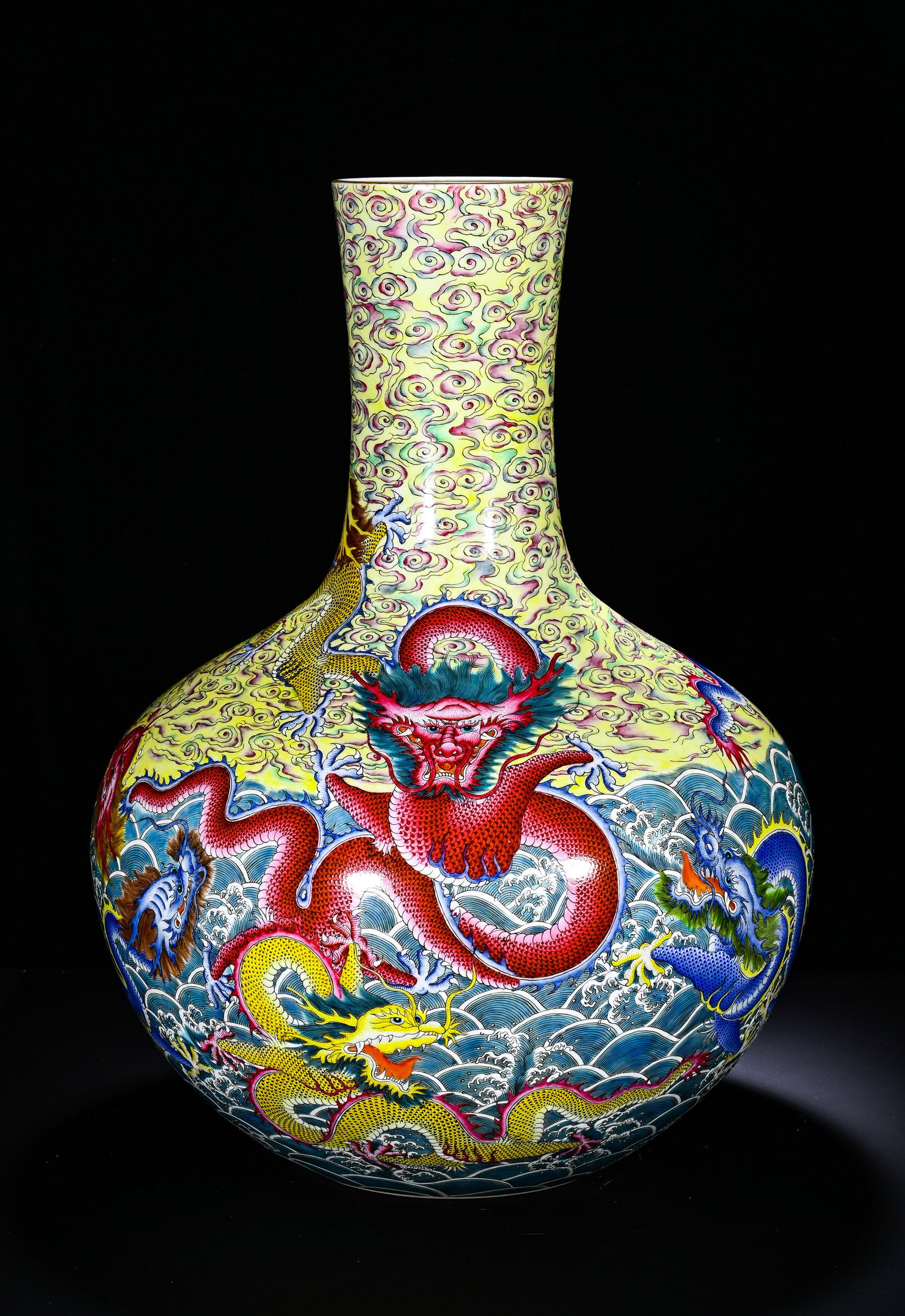 QING DYNASTY QIANLONG PASTEL CLOUD SEA WATER FIVE DRAGONS PATTERN CELESTIAL GLOBE BOTTLE: Height: 55cm(21.65in), Diameter: 36cm(14.17in)This is a Qianlong?period famille?rose celestial?globe vase decorated with auspicious?cloud, seawater and five?dragon motifs. Straight neck and huge spher
