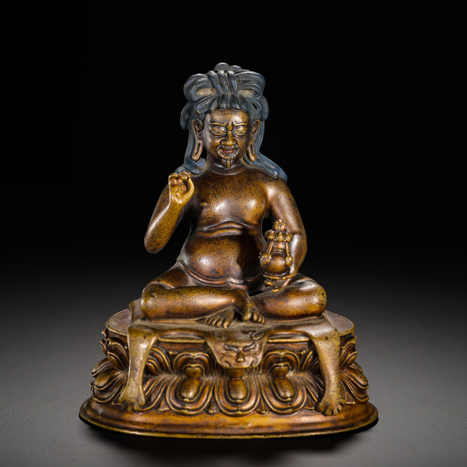A BRONZE STATUE OF MILAREPA FROM THE QING DYNASTY: Height: 14cm(5.51in) Width: 11.5cm(4.53in) Weight: 770g(1.70lb)Purple copper statue of Milarepa, Qing Tibetan Buddhism. The guru sits in full lotus pose with plump bare torso, high topknot painted blu