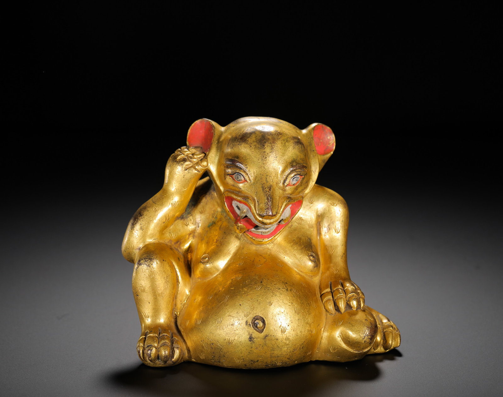A GILDED BRONZE OFFERING ORNAMENT FROM THE QING DYNASTY: Height: 12cm(4.72in) Width: 13cm(5.12in) Weight: 1360g(3.00lb)Fully gilded copper treasure-spitting mongoose ornament, Qing Tibetan Buddhism. The auspicious beast matched with Yellow Jambhala features