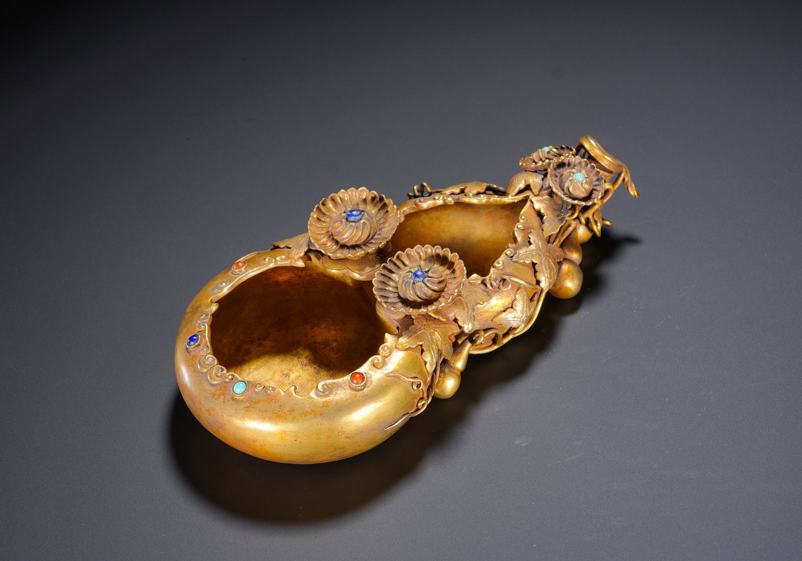SILVER-GILT GOURD-SHAPED PEN WASHERS OF THE MING DYNASTY: Height: 5cm(1.97in), Width: 19.5cm(7.68in), Weight: 490g (1.080lb)The gourd symbolises fortune and longevity; trailing vines and abundant fruits signify continuous blessings and prosperous descendants
