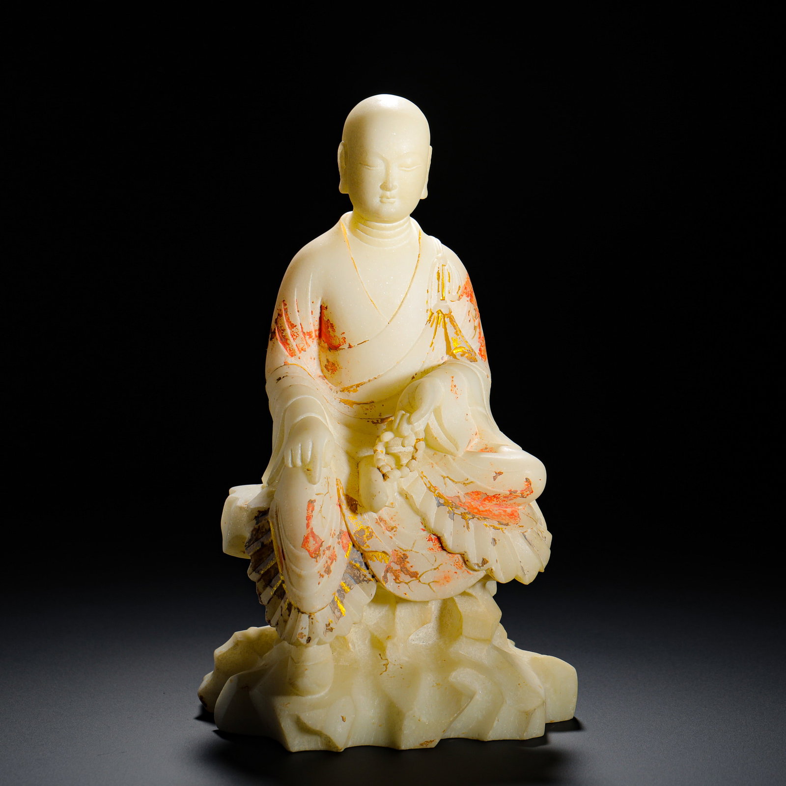 A SEATED STATUE OF THE BODHISATTVA JIN DI ZANG PAINTED ON WHITE MARBLE FROM THE HAN DYNASTY: Height: 25cm(9.84in) Width: 13.5cm(5.31in) Weight: 2760g(6.08lb)White marble Ksitigarbha seated statue with painted red & gilded robes. Carved from single marble block, the monk-headed Bodhisattva bea
