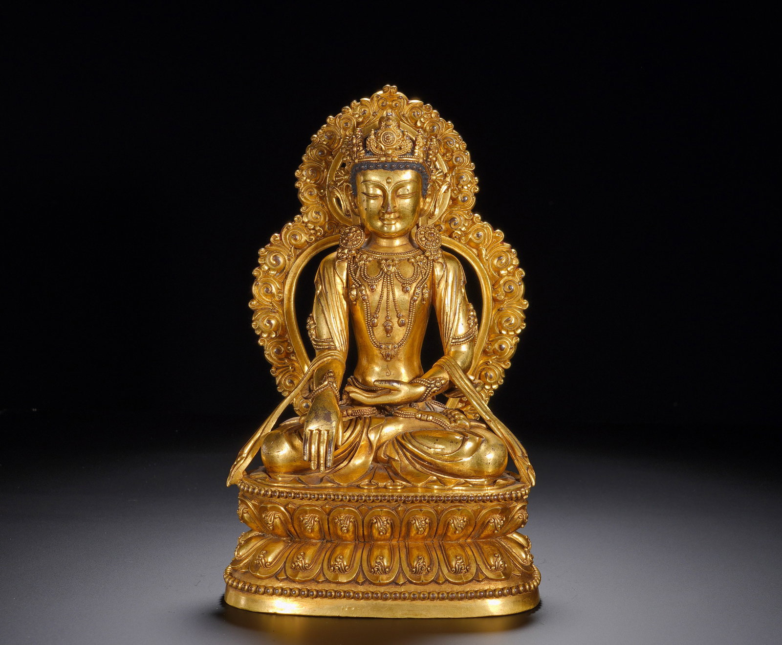 A GILDED BRONZE STATUE OF SAKYAMUNI BUDDHA WITH A CROWN FROM YONGLE, MING DYNASTY: Height: 24cm(9.45in), Width: 16cm(6.30in), Weight: 3120g (6.878lb)Crowned Shakyamuni embodies complete wisdom and merit. Yongle-marked gilt bronzes represent the pinnacle of Sino-Tibetan Buddhist art 
