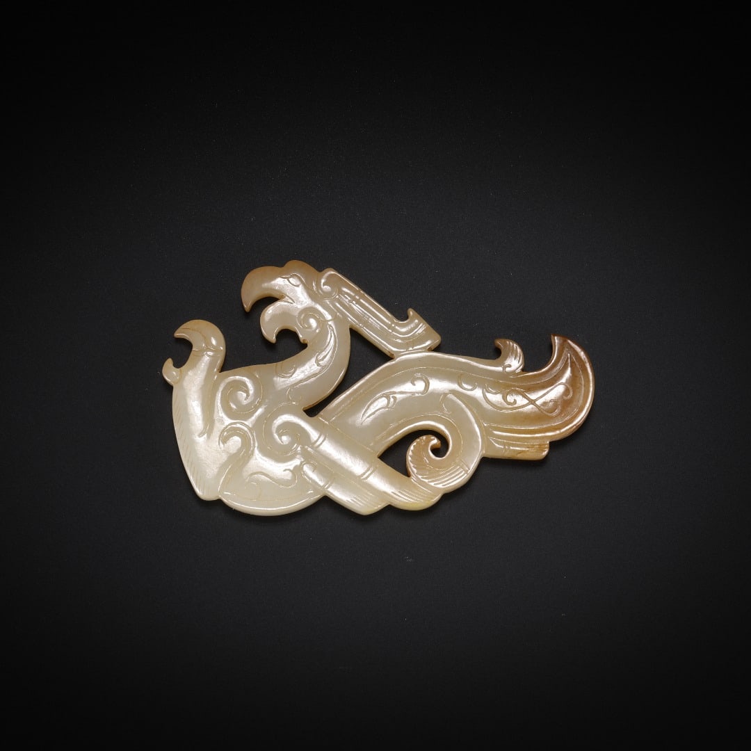 HANHETIAN JADE PHOENIX PENDANT: Long: 6.1cm(2.40in), Width: 3.7cm(1.46in), Thick: 0.5cm(0.20in), Weight: 18g (0.040lb)Crafted from Hetian white jade with light russet patina in partial areas. Openwork depicts two interdependent phoe