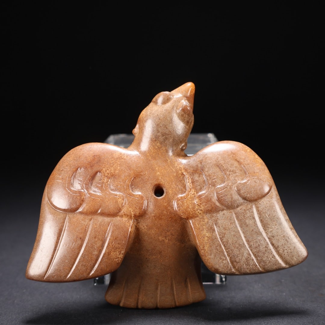 HAN DYNASTY HETIAN JADE PHOENIX: Long: 9.3cm(3.66in), Width: 7.8cm(3.07in), Height: 3cm(1.18in), Weight: 147g (0.324lb)Carved from ancient jade covered in mellow brown patina. The divine bird lifts its head with fully outstretched wi